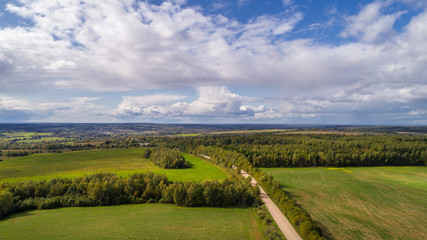 Fototapeta na wymiar landscape aerial view summer day. beautiful image bird's-eye views of fields and forest and roads and settlements