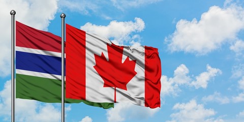 Gambia and Canada flag waving in the wind against white cloudy blue sky together. Diplomacy concept, international relations.
