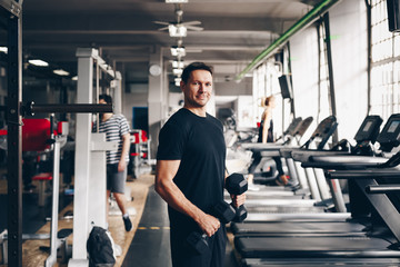 authentic image, portrait of healthy fit fitness coach in a gym. concept of active living and...