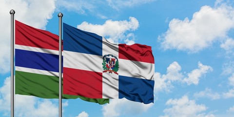 Gambia and Dominican Republic flag waving in the wind against white cloudy blue sky together. Diplomacy concept, international relations.