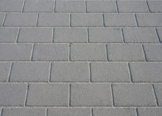 Texture of concrete walkway brick floor in perspective closeup background.