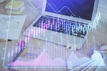 Forex market graph hologram and personal computer on background. Multi exposure. Concept of investment.