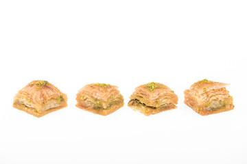 traditional turkish honey baklava with nuts in row isolated on white