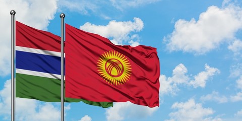 Gambia and Kyrgyzstan flag waving in the wind against white cloudy blue sky together. Diplomacy concept, international relations.