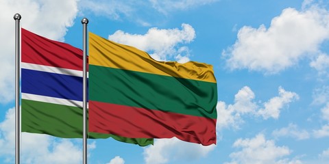 Gambia and Lithuania flag waving in the wind against white cloudy blue sky together. Diplomacy concept, international relations.