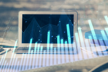 Financial market graph hologram and personal computer on background. Multi exposure. Concept of forex.