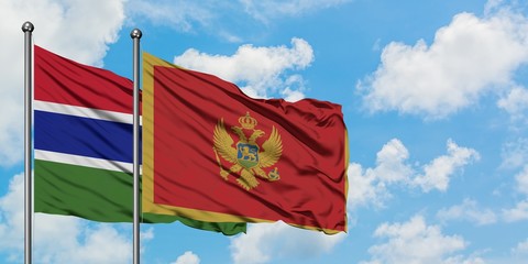 Gambia and Montenegro flag waving in the wind against white cloudy blue sky together. Diplomacy concept, international relations.