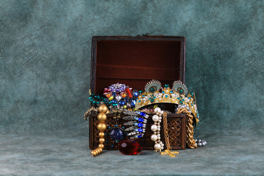 Open treasure chest on a green background