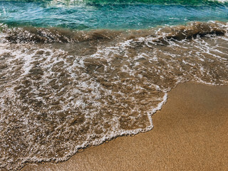 Sea coast, blue sea wave close-up and yellow sandy beach. Montenegro, Adritica, Balkans.