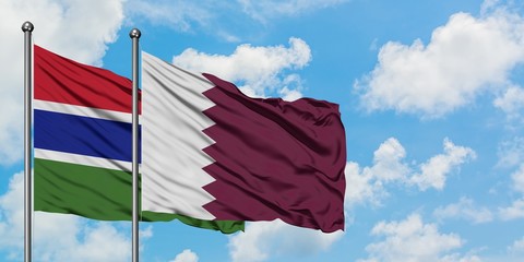 Gambia and Qatar flag waving in the wind against white cloudy blue sky together. Diplomacy concept,...