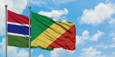 Gambia and Republic Of The Congo flag waving in the wind against white cloudy blue sky together. Diplomacy concept, international relations.