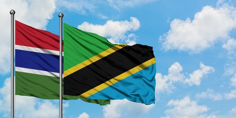 Gambia and Tanzania flag waving in the wind against white cloudy blue sky together. Diplomacy concept, international relations.