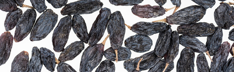 top view of black raisins isolated on white, panoramic shot