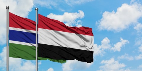 Gambia and Yemen flag waving in the wind against white cloudy blue sky together. Diplomacy concept, international relations.