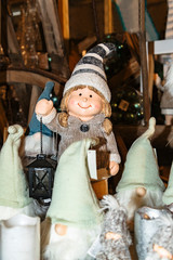 Fototapeta na wymiar Christmas toy ceramic girl Leprechaun holding lamp