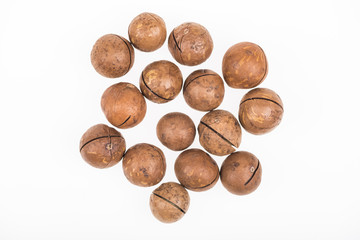 top view of Macadamia nuts scattered isolated on white