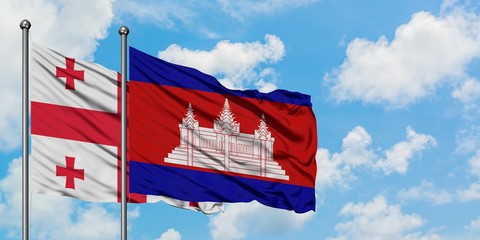 Georgia and Cambodia flag waving in the wind against white cloudy blue sky together. Diplomacy concept, international relations.