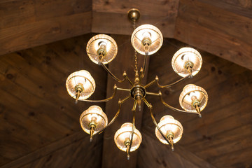 Round lights hanging on a wooden ceiling. Vintage lamp hanging from ceiling