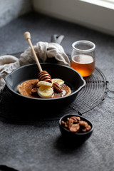 Pancakes with banana, walnuts and honey. Morning concept