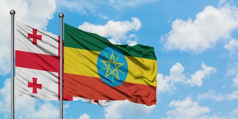 Georgia and Ethiopia flag waving in the wind against white cloudy blue sky together. Diplomacy concept, international relations.