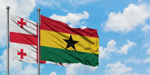 Georgia and Ghana flag waving in the wind against white cloudy blue sky together. Diplomacy concept, international relations.