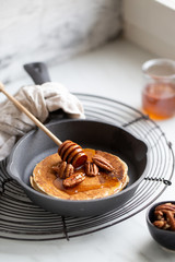 Pancakes with banana, walnuts and honey. Morning concept
