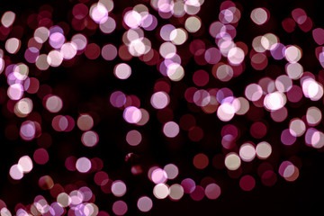 Purple, pink bokeh on a black background. Abstraction