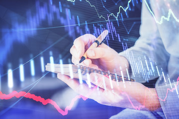 Double exposure hands with stock market chart.
