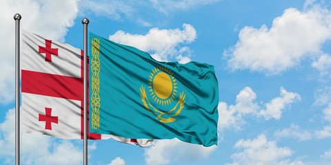 Georgia and Kazakhstan flag waving in the wind against white cloudy blue sky together. Diplomacy concept, international relations.