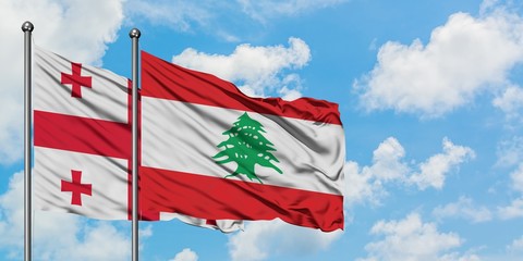Georgia and Lebanon flag waving in the wind against white cloudy blue sky together. Diplomacy concept, international relations.