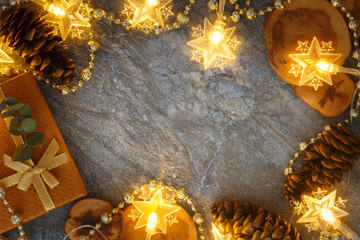 Xmas composition with natural wood slices, New year golden bead garland. Winter holidays concept.