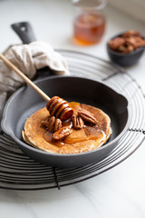 Pancakes with banana, walnuts and honey. Morning concept