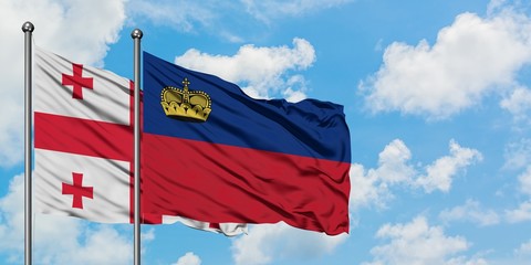 Georgia and Liechtenstein flag waving in the wind against white cloudy blue sky together. Diplomacy concept, international relations.