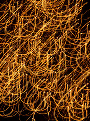 Golden abstract looped lines on a black background. Abstraction