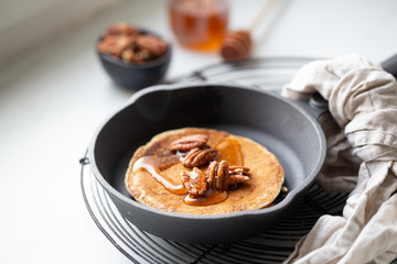 Pancakes with banana, walnuts and honey. Morning concept
