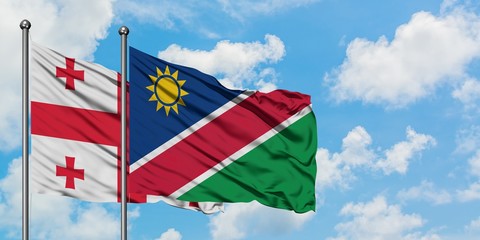 Georgia and Namibia flag waving in the wind against white cloudy blue sky together. Diplomacy concept, international relations.
