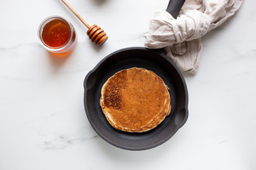 Pancakes with banana, walnuts and honey. Morning concept