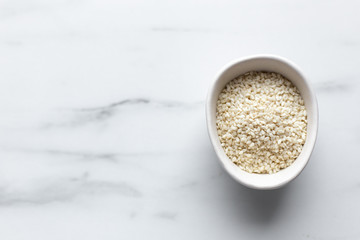 Sesame seeds on marble background with copy space