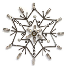 The snowflake of screws, washers, nuts on a white isolated background. View from above. Conceptual...