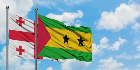Georgia and Sao Tome And Principe flag waving in the wind against white cloudy blue sky together. Diplomacy concept, international relations.