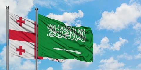 Georgia and Saudi Arabia flag waving in the wind against white cloudy blue sky together. Diplomacy...