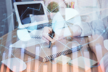 Financial charts displayed on woman's hand taking notes background. Concept of research. Double exposure