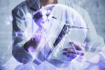 Financial chart drawn over hands taking notes background. Concept of research. Multi exposure