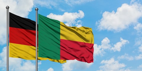 Germany and Benin flag waving in the wind against white cloudy blue sky together. Diplomacy concept, international relations.