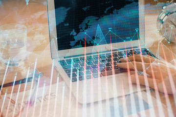 Multi exposure of market chart with man working on computer on background. Concept of financial analysis.