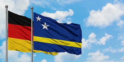 Germany and Curacao flag waving in the wind against white cloudy blue sky together. Diplomacy concept, international relations.