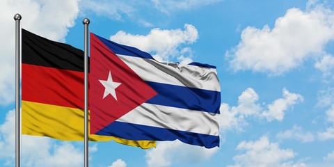 Germany and Cuba flag waving in the wind against white cloudy blue sky together. Diplomacy concept, international relations.