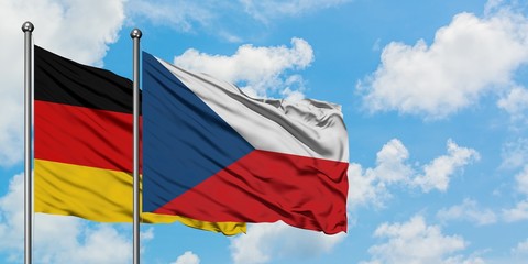 Germany and Czech Republic flag waving in the wind against white cloudy blue sky together. Diplomacy concept, international relations.