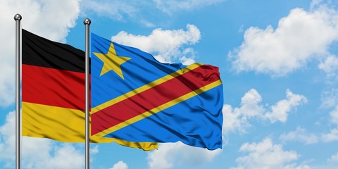 Germany and Congo flag waving in the wind against white cloudy blue sky together. Diplomacy concept, international relations.