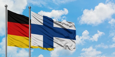 Germany and Finland flag waving in the wind against white cloudy blue sky together. Diplomacy concept, international relations.